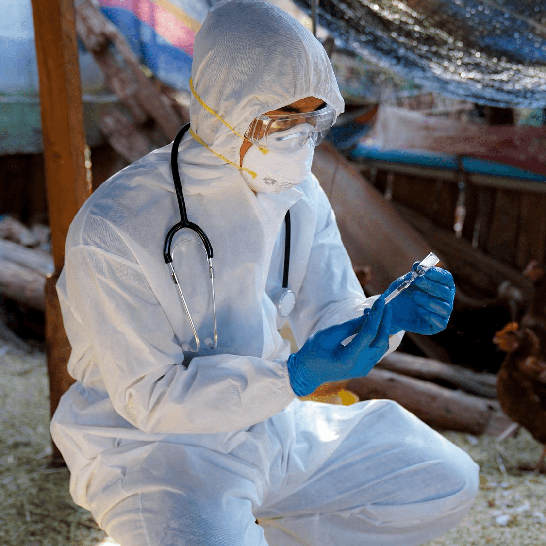 a researcher holding a syringe
